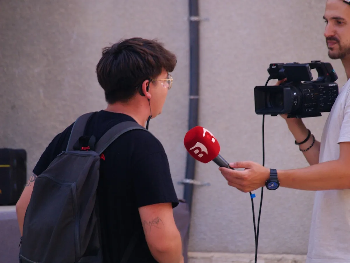 Clip two: a sunny street interview with a red foam microphone, cropped to a vertical frame